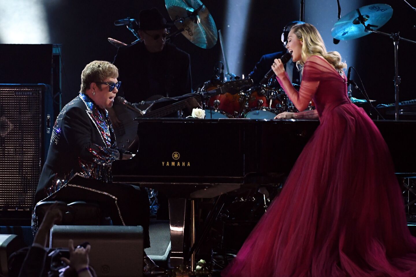 Sir Elton John, left, and Miley Cyrus perform his "Tiny Dancer."