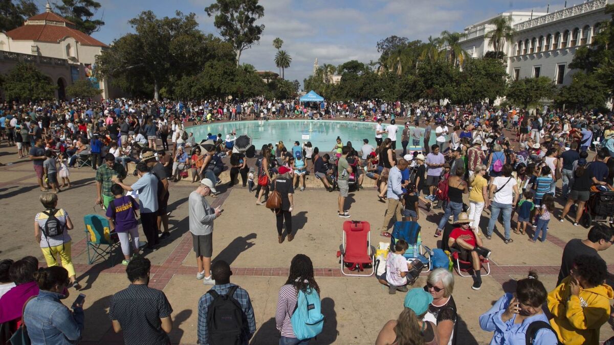 More than 1,000 people gathered outside around Balboa Park's Bea Evenson Fountain in August to watch the partial solar eclipse.