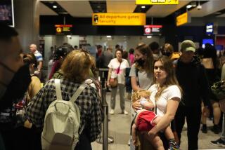 Travelers queue at security at Heathrow Airport in London, Wednesday, June 22, 2022.