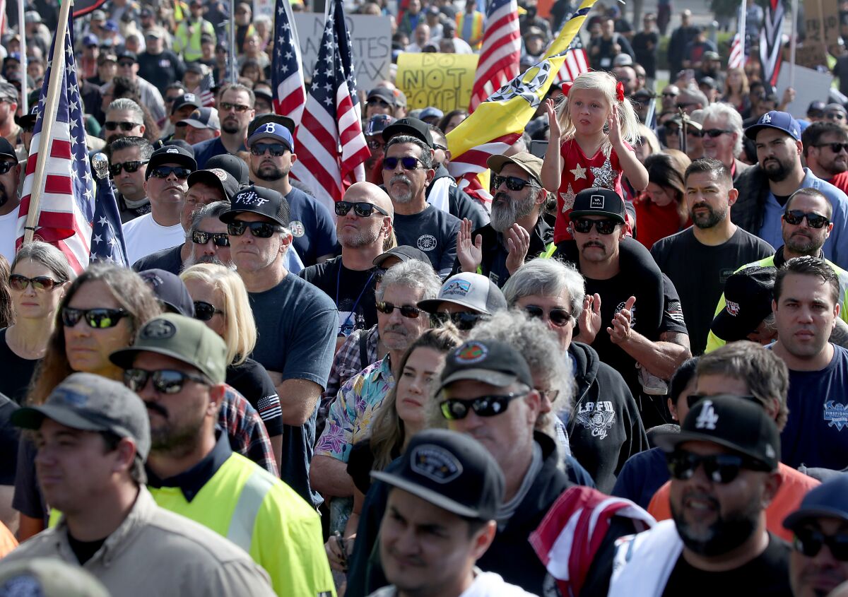 Hundreds of people opposed to vaccination mandates protest at Grand Park in downtown Los Angeles on Nov. 8.