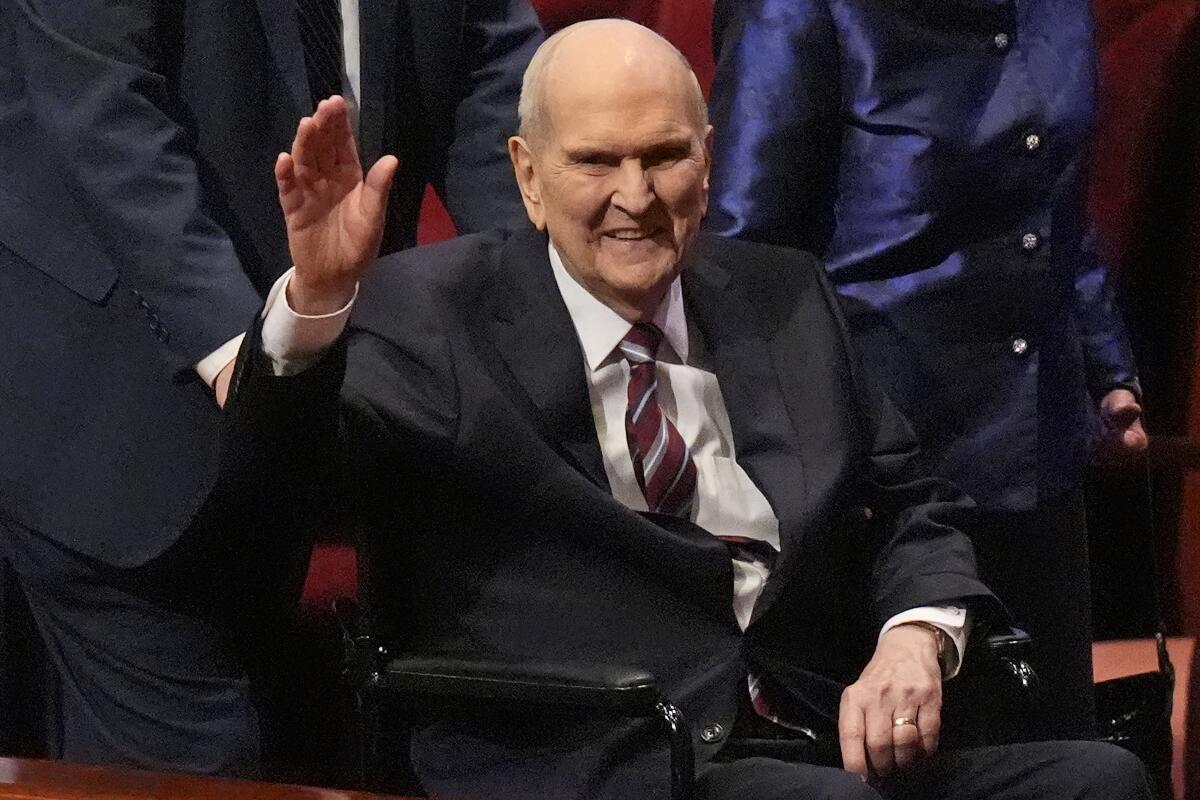 President of The Church of Jesus Christ of Latter-day Saints Russell M. Nelson waves.