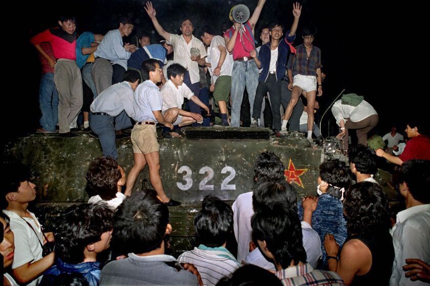 FILE - In this early June 4, 1989 file photo, civilians with rocks stand on a government armored vehicle near Chang'an Boulevard in Beijing as violence escalated between pro-democracy protesters and Chinese troops, leaving hundreds dead overnight. China’s last-known prisoner held in relation to the 1989 Tiananmen Square protests will reportedly be released Saturday, Oct. 15, 2016 but he’ll face freedom a frail and mentally ill man, a rights group and a fellow former inmate said. Miao Deshun’s expected release follows an 11-month sentence reduction, according to the Dui Hua Foundation, a San Francisco-based group that advocates for the rights of political prisoners in China. (AP Photo/Jeff Widener, File)