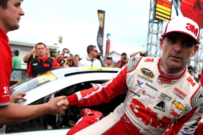 NASCAR driver Jeff Gordon is congratulated Saturday as he climbs out of his car after winning the pole position for the Sprint Cup race at Talladega Superspeedway.