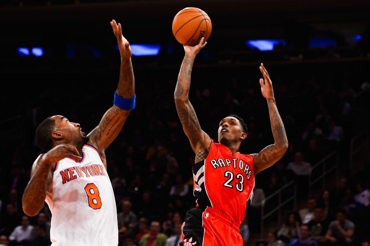 Toronto Raptors guard Lou Williams shoots over New York Knicks guard J.R. Smith during a game on Oct. 13. Williams has joined the Lakers.