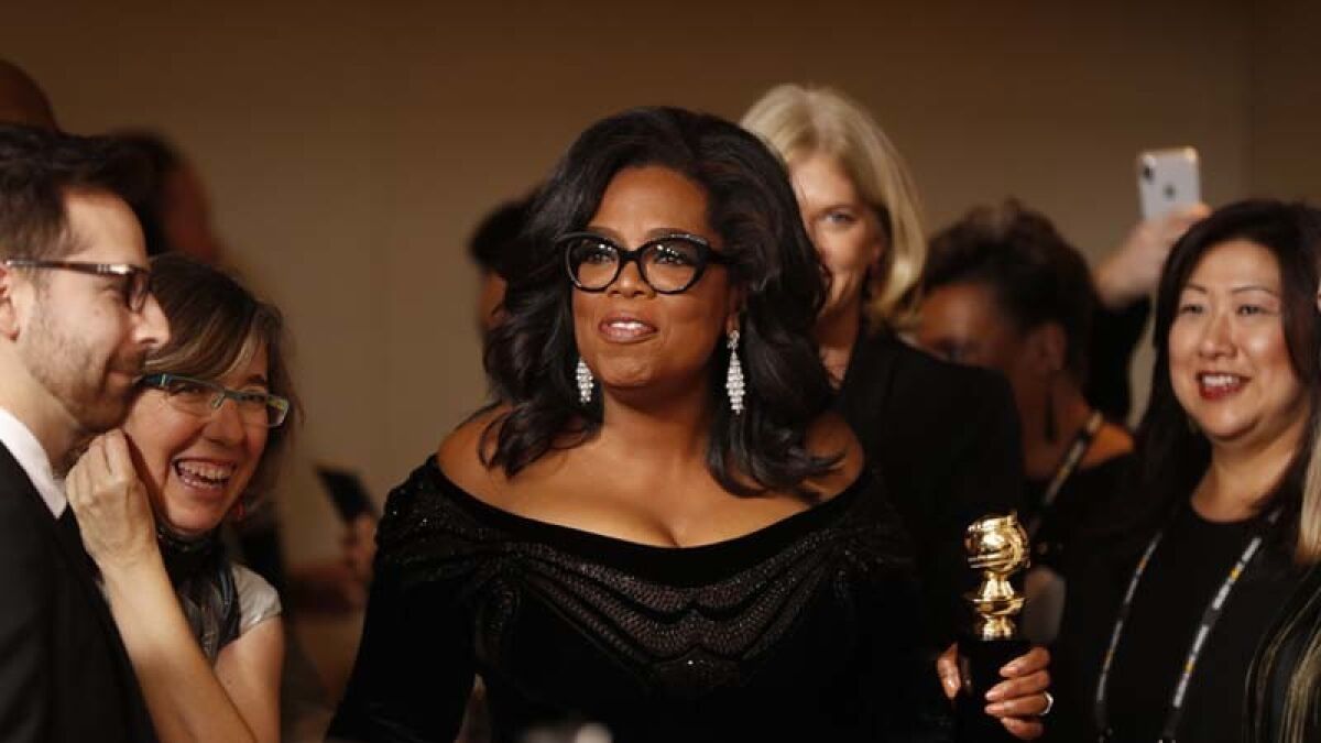 Oprah Winfrey with her Cecil B. DeMille Award backstage at the Golden Globes.