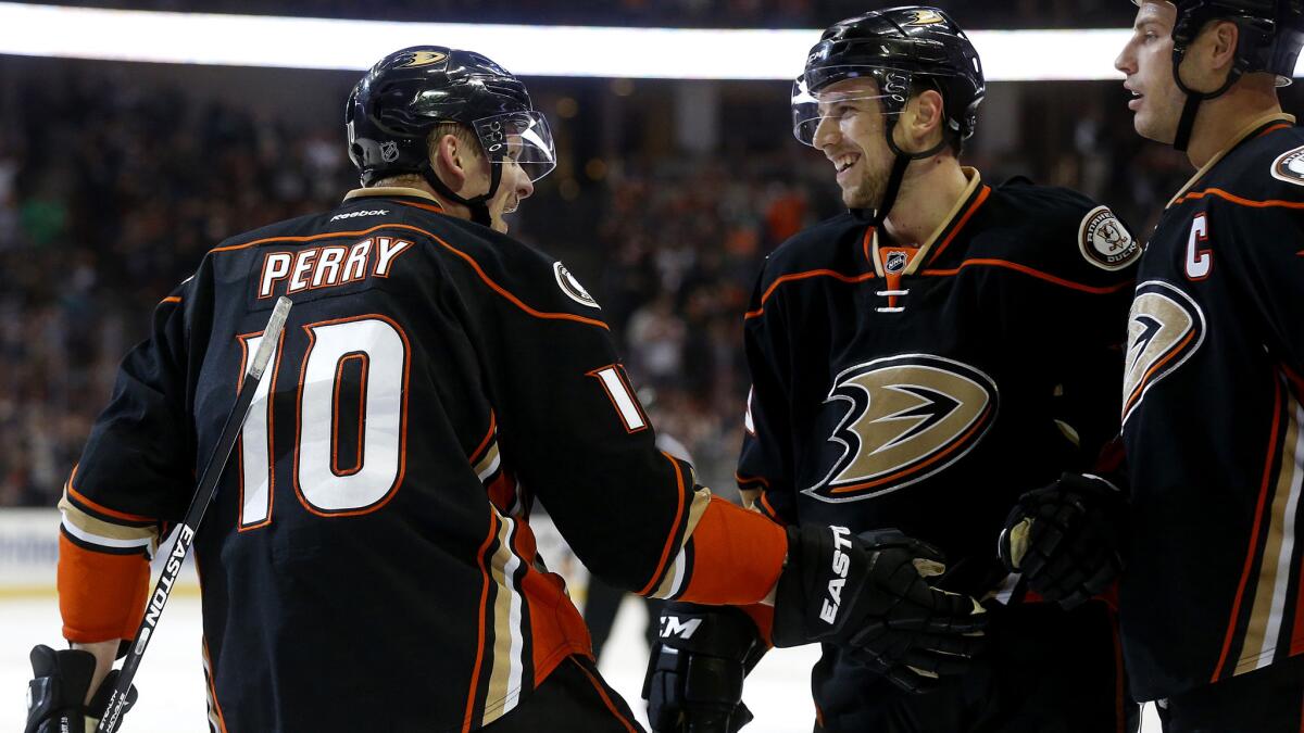 Ducks right wing Corey Perry celebrates with teammates after scoring a goal against the Stars in the first period Friday night.