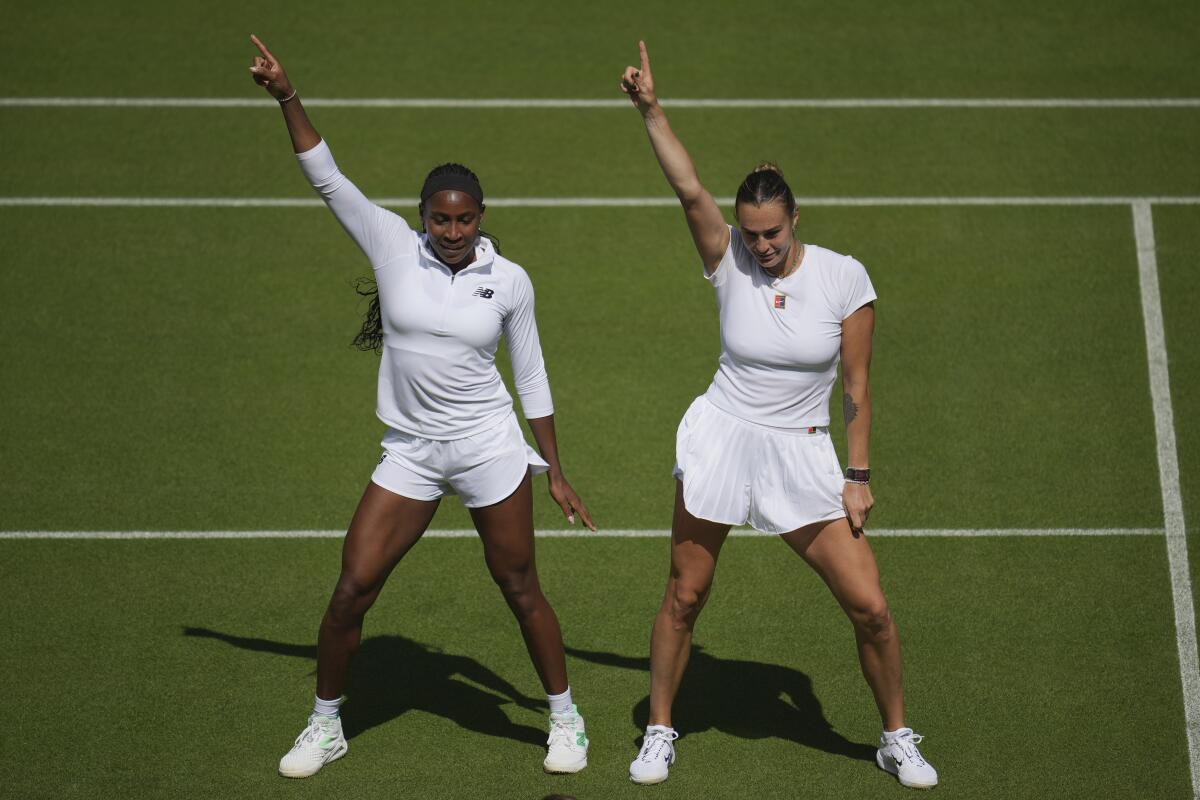 Coco Gauff, left, and Aryna Sabalenka dance on the court Friday during a practice session ahead of the Wimbledon tournament.