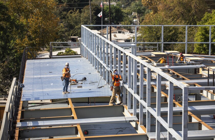 Workers install decking this month at Cleveland Charter High in Reseda.