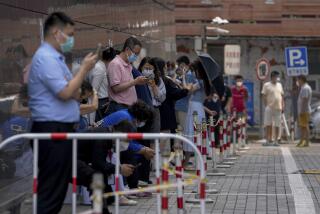 People wearing face masks stand in line as they wait for mass COVID-19 tests at a coronavirus testing site in Beijing, Thursday, June 16, 2022. (AP Photo/Andy Wong)