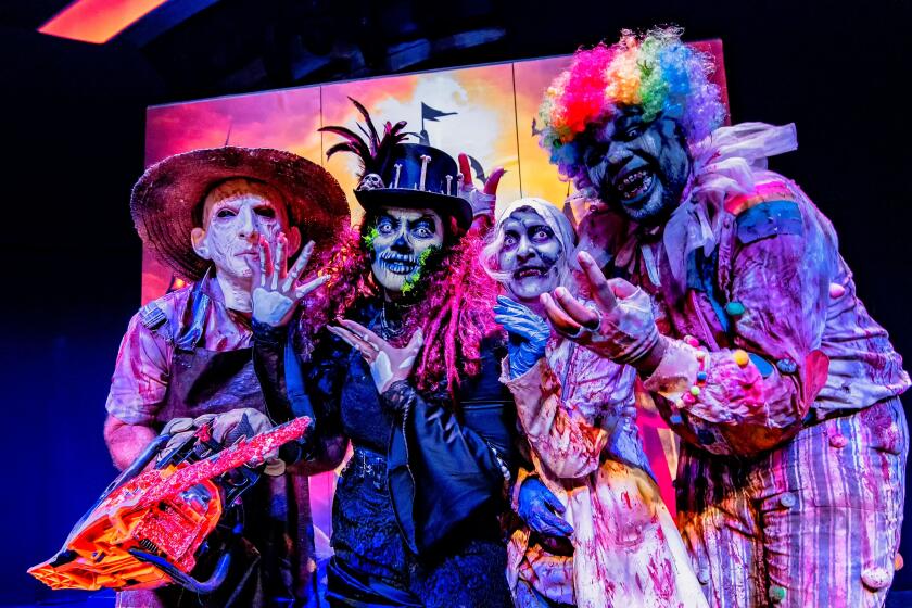 A group of clowns and other spooky characters pose at SeaWorld's Howl-O-Scream in 2022.
