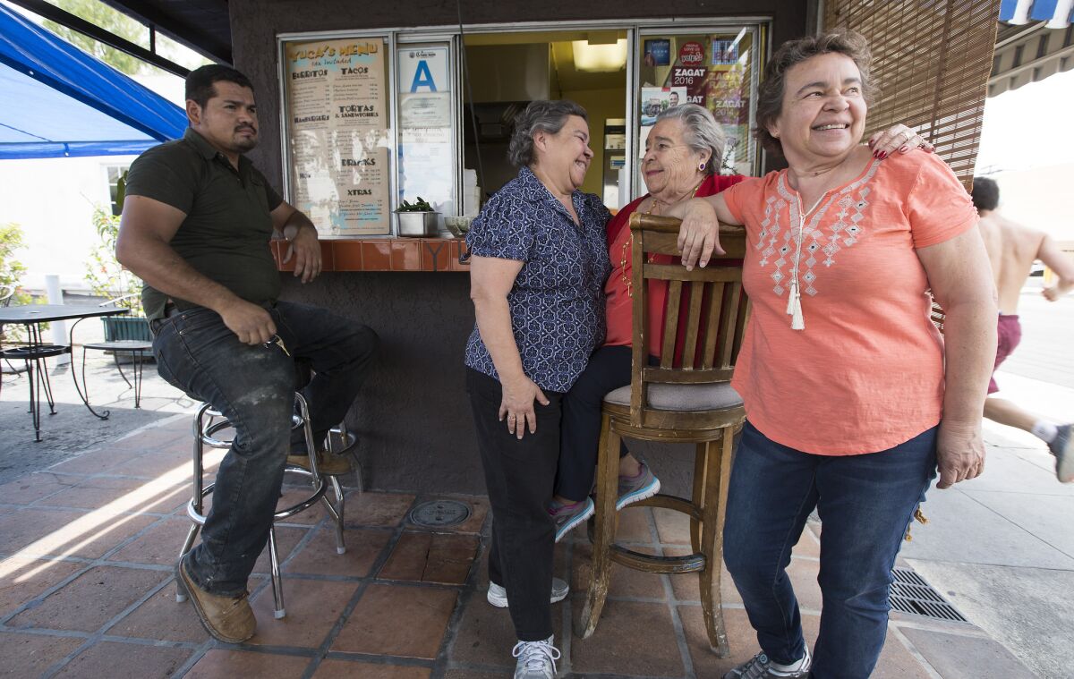 Soccoro Herrera, center, with daughters Dora, left, and Margarita, right, at Yuca's.