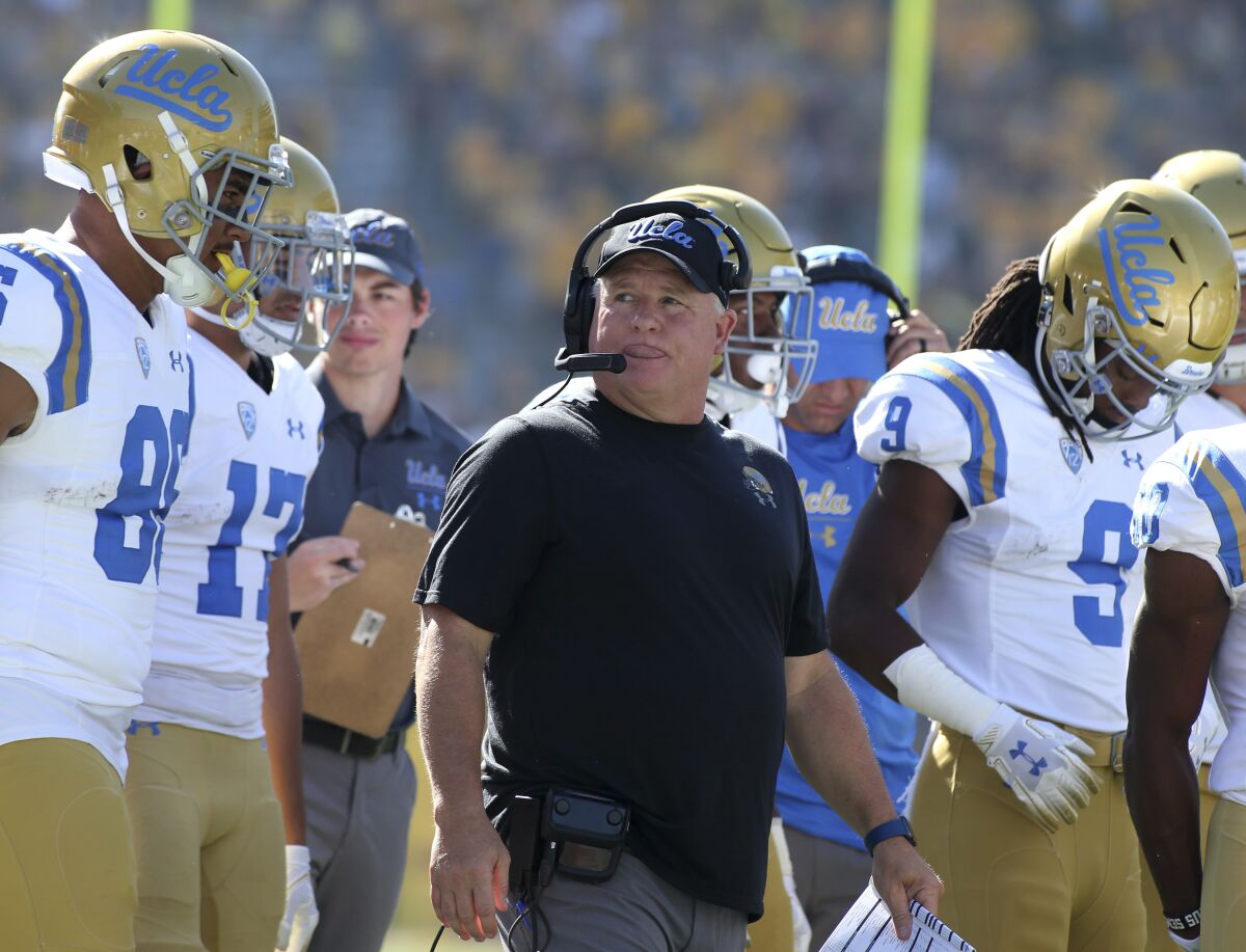 UCLA head coach Chip Kelly walks with his players prior to a game against Arizona State on Nov. 10, 2018.