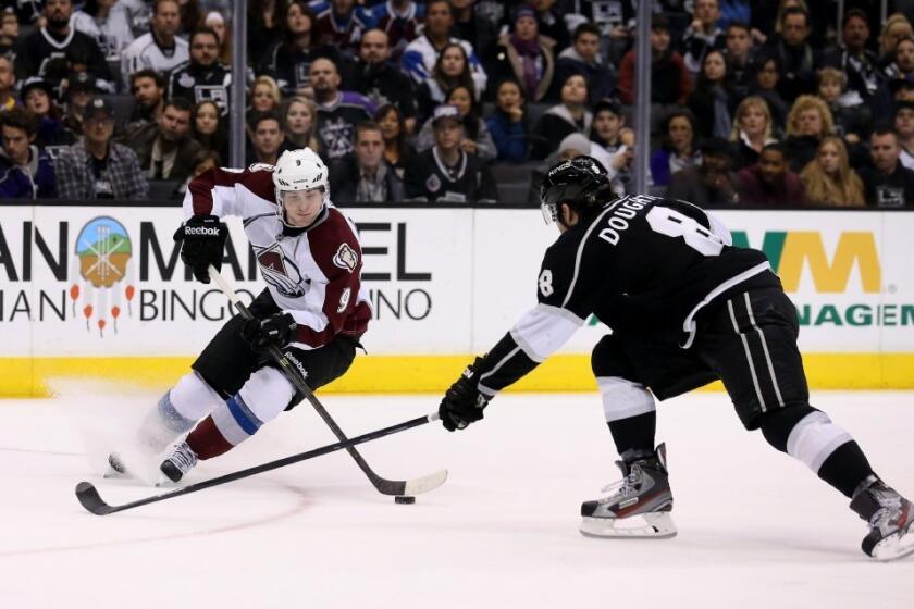 Kings' Drew Doughty, right, battles for the puck on Dec. 21.