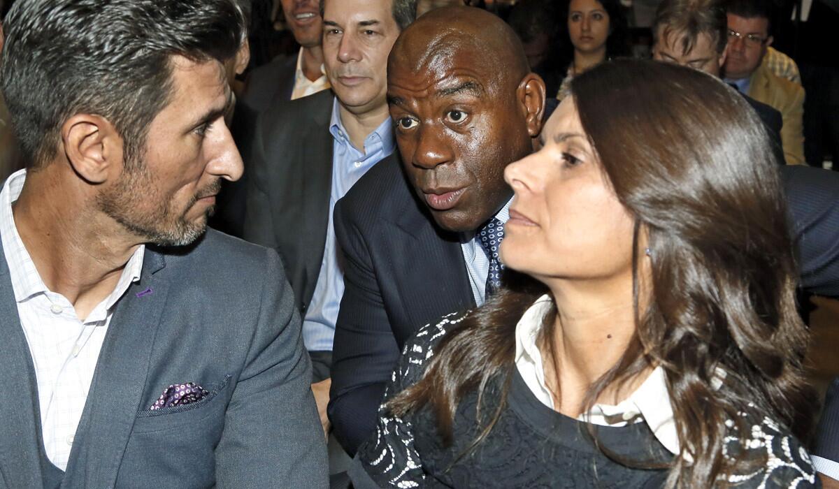 Magic Johnson chats with Nomar Garciaparra, left, and Mia Hamm during a news conference Thursday to announce the launch of a second MLS team in Los Angeles.