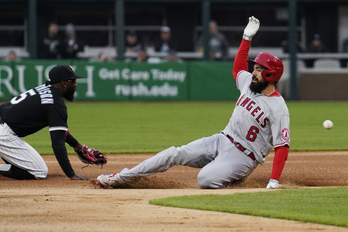 Angels baserunner Anthony Rendon, right, slides safely into second base after hitting a double Friday.