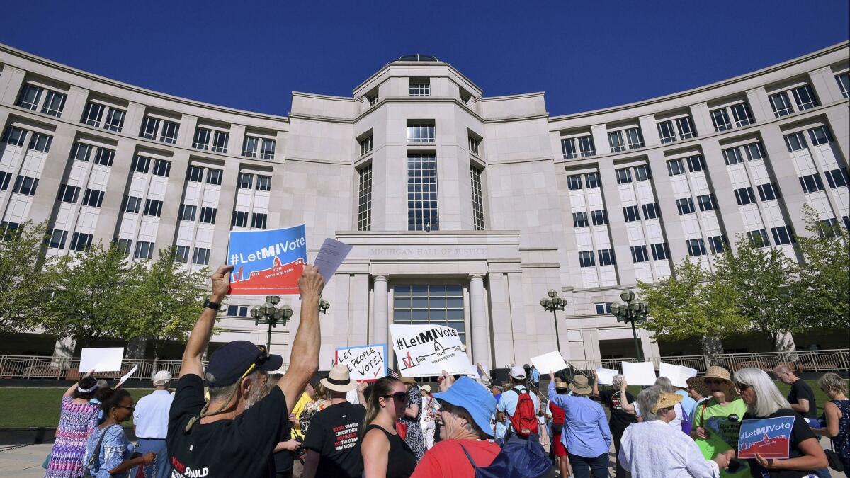 Demonstrators rally in Lansing, Mich. on July 18, as the state's Supreme Court heard arguments about whether voters should be able to pass a constitutional amendment that would change how the state's voting maps are drawn.