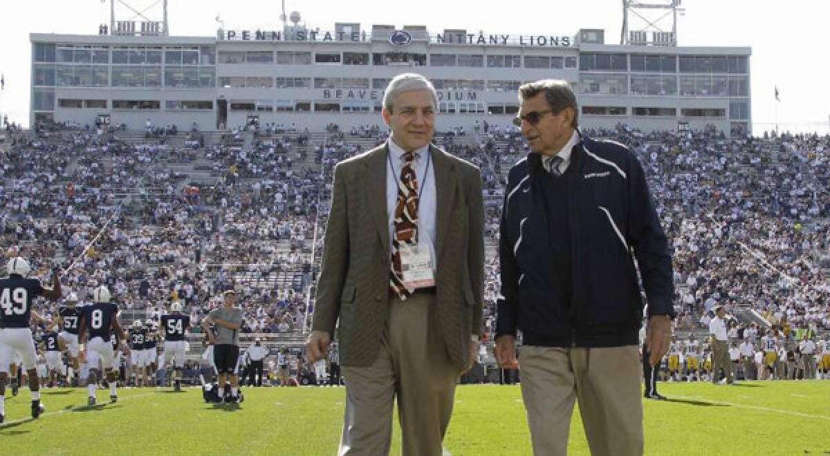 Penn State President Graham Spanier, left, and head football coach Joe Paterno chat before a game against Iowa in State College, Pa., before the child abuse scandal cost them their positions.