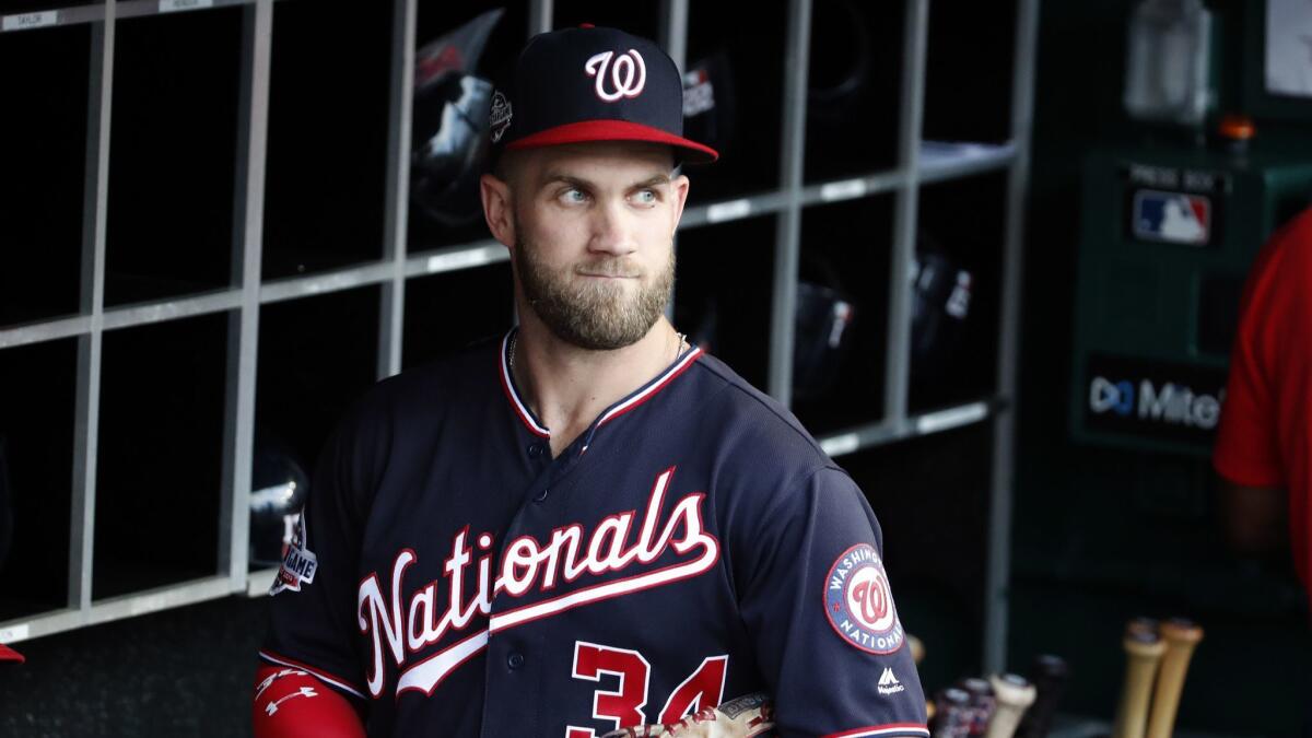 Bryce Harper walks in the dugout before a game between the Washington Nationals and New York Mets on July 31, 2018.