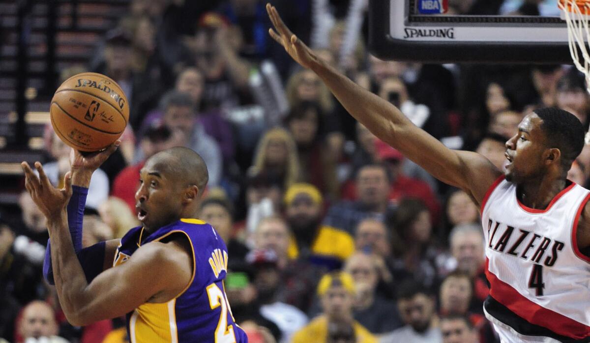 Kobe Bryant (i) en una ofensiva de los Lakers, ante la presión de Maurice Harkless, de Trail Blazers, en Portland.
