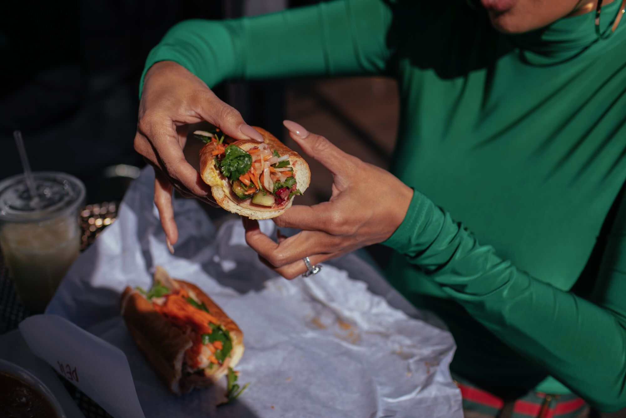 A person holds a sandwich.
