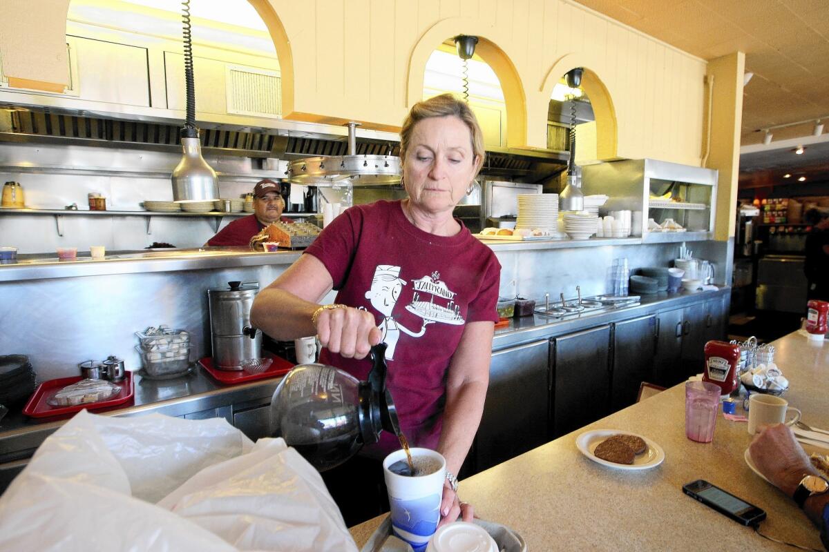 Tally Rand day manager Sue Thomas pours a cup of joe on Thursday, June 5, 2014.