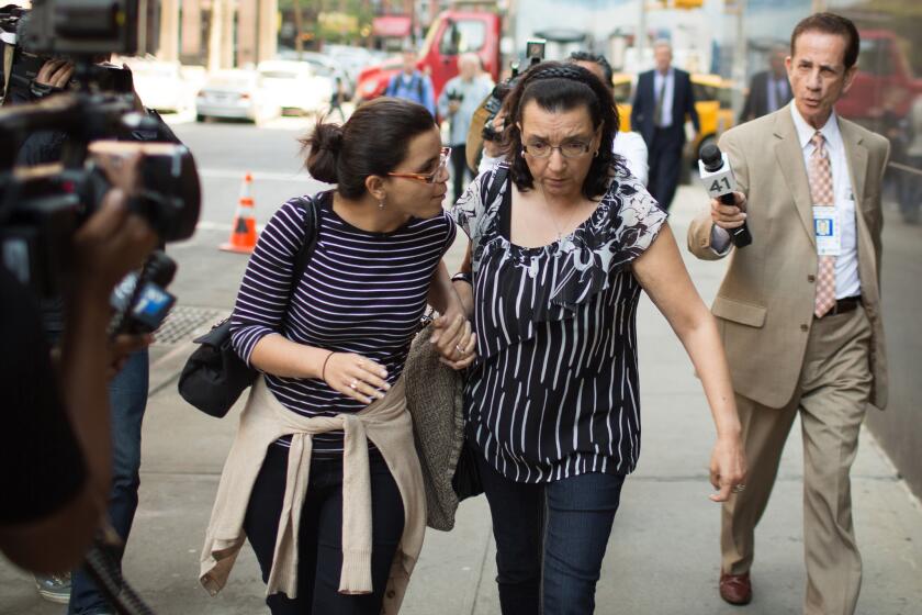 Pedro Hernandez’s daughter, Becky Hernandez (left), holds hands with her mother, Rosemary Hernandez, as they exit court on May 8.