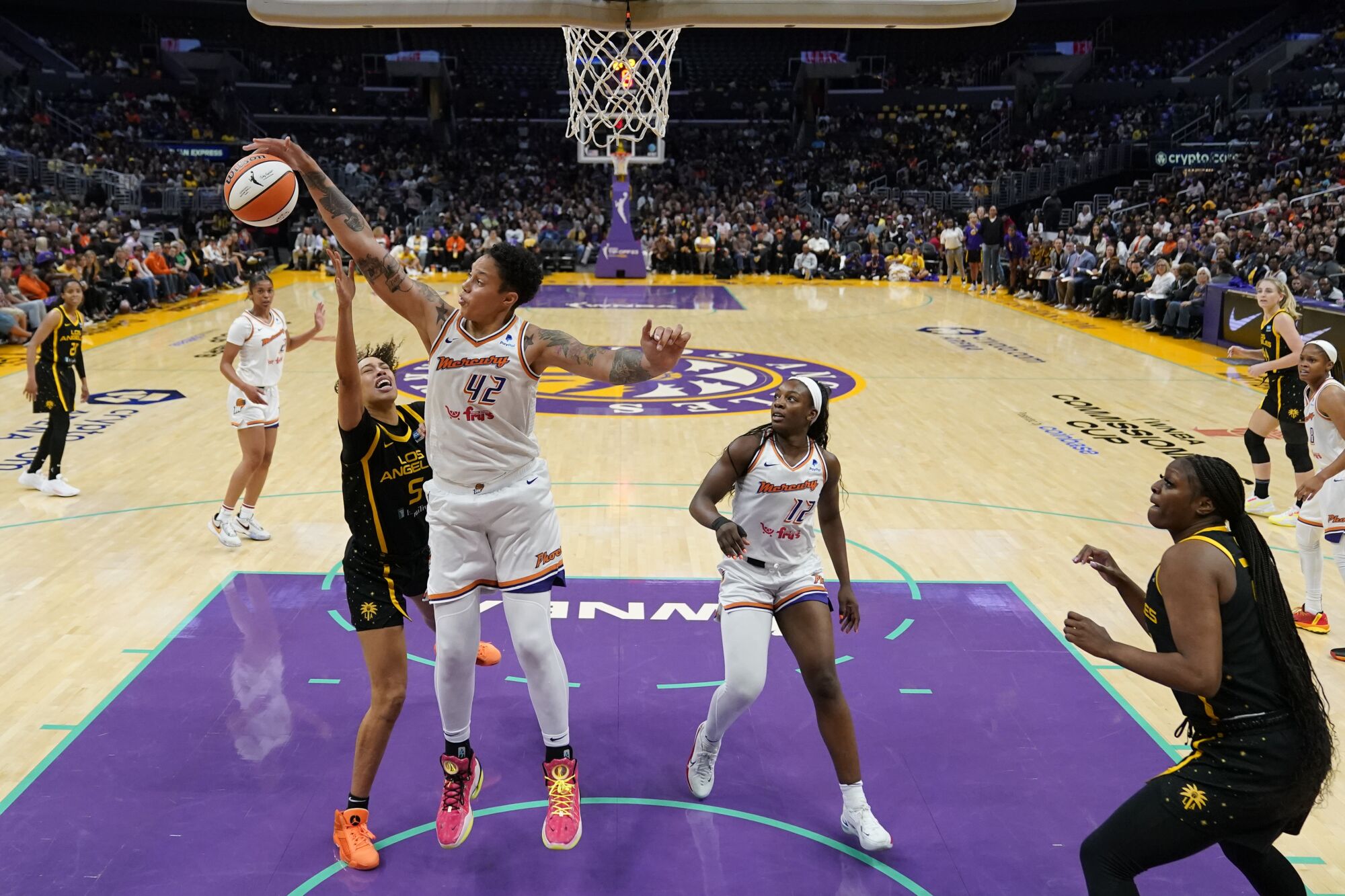 Mercury center Brittney Griner blocks a shot by Sparks guard Dearica Hamby