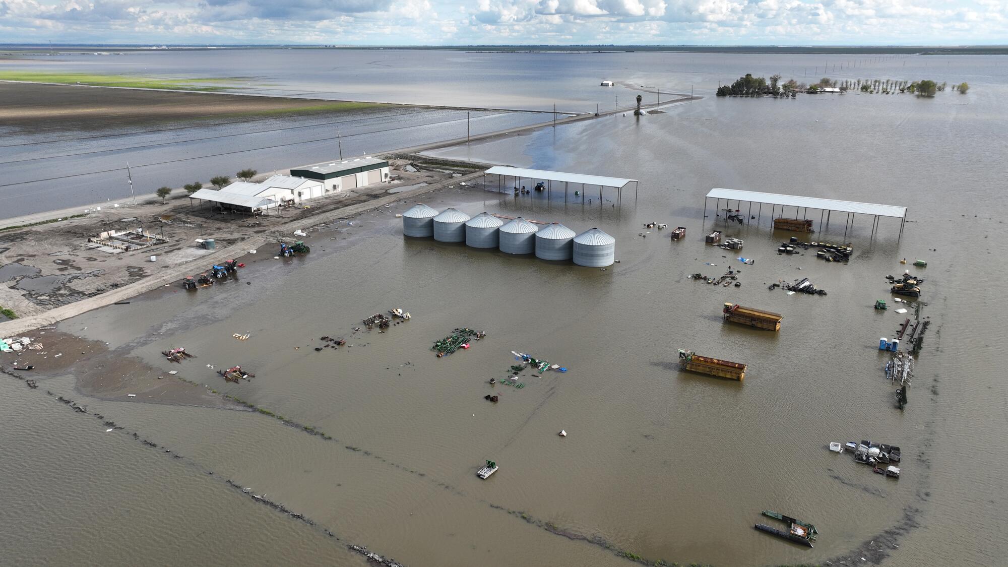 Waters fill an agricultural equipment yard.