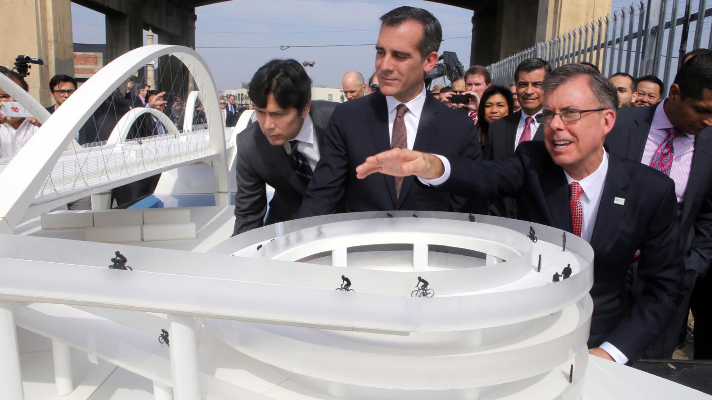 Los Angeles City Engineer Gary Moore, right, Mayor Eric Garcetti and others look at a model of the new 6th Street Viaduct. Michael Maltzan is the architect and designer.