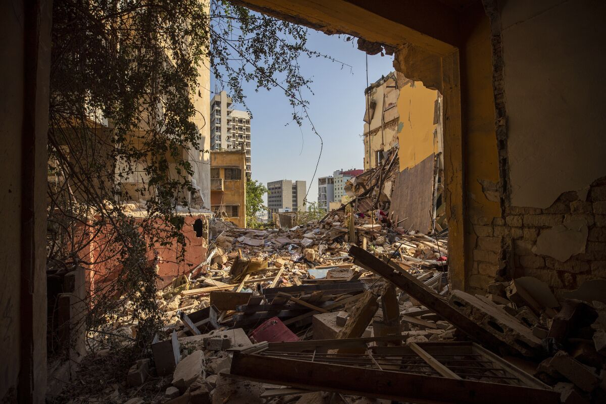 Destroyed buildings are seen from a room heavily damaged in a neighborhood near the site of last week's explosion that hit the seaport of Beirut Beirut, Lebanon, Wednesday, Aug. 12, 2020. (AP Photo/Hassan Ammar)