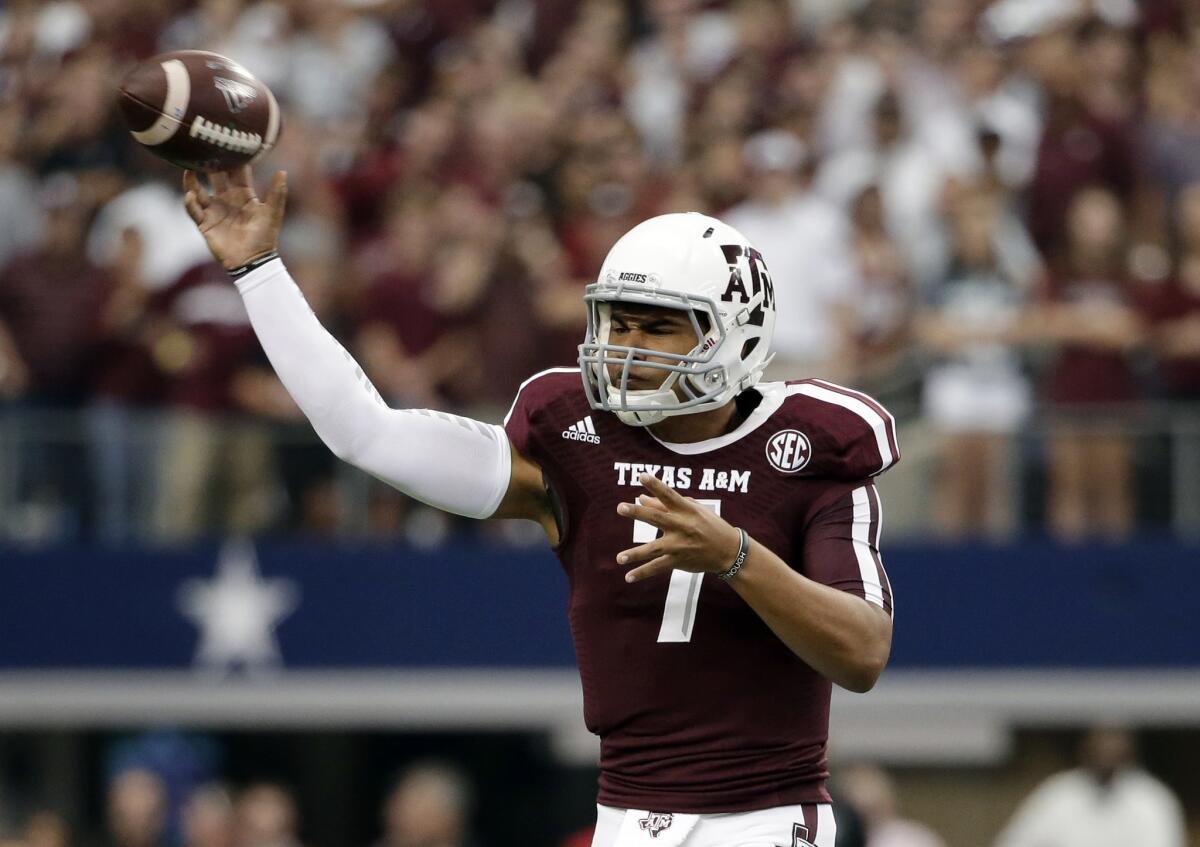 Quarterback Kenny Hill helped rally Texas A&M to victory with four touchdown passes against Arkansas on Saturdya.