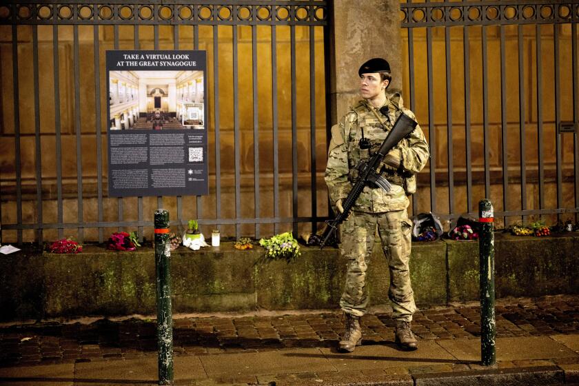 FILE - A soldier of the Danish Army (Forsvaret) guards the Copenhagen Synagogue, Saturday Dec. 16, 2023. The number of antisemitic incidents registered in Denmark since the Oct. 7 attack on Israel that that ignited the war in Gaza has never been as high, with the head of the Scandinavian country's small Jewish community calling it the biggest wave since World War II. The figures are in par with what has been reported in other European countries. (Nils Meilvang/Ritzau Scanpix via AP, File)