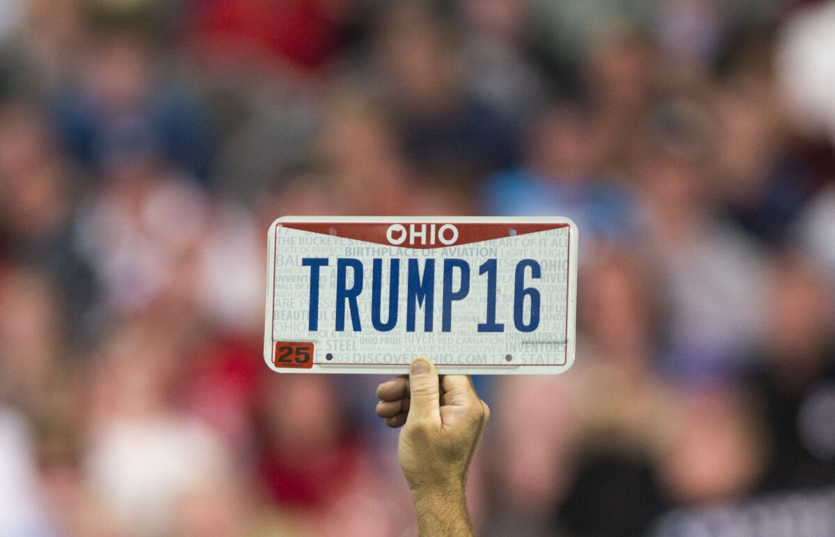 A supporter holds up a personalized license plate labeled "Trump16" during a campaign rally for Republican presidential candidate Donald Trump in Columbus, Ohio, on Nov. 23.