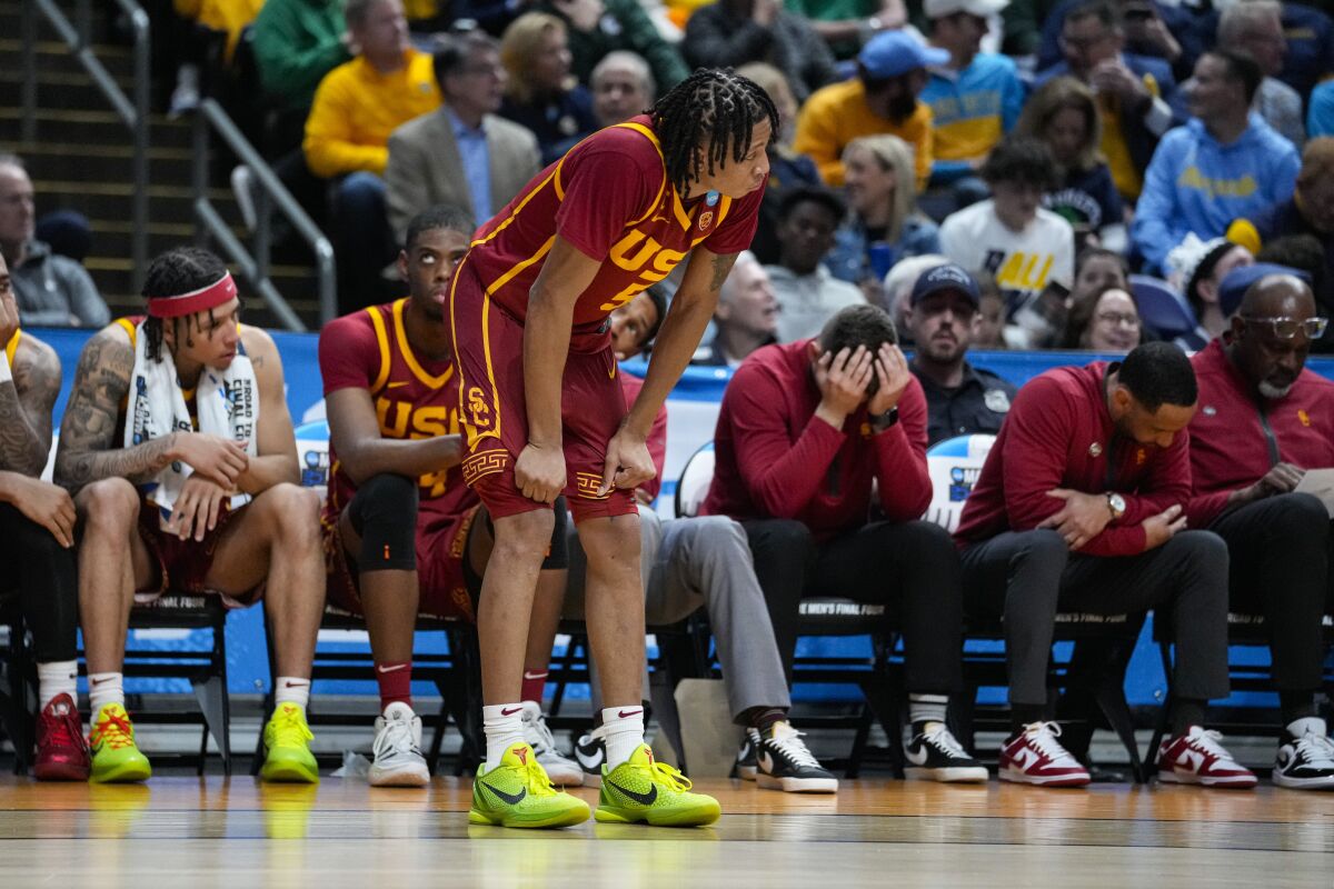 USC guard Boogie Ellis tugs on his shorts in front of the Trojans bench