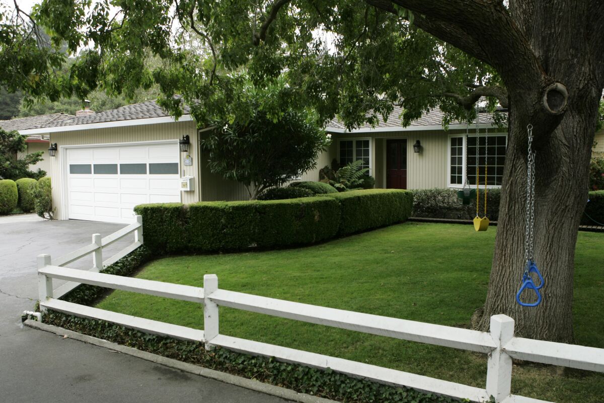 The front lawn and garage of a suburban home.