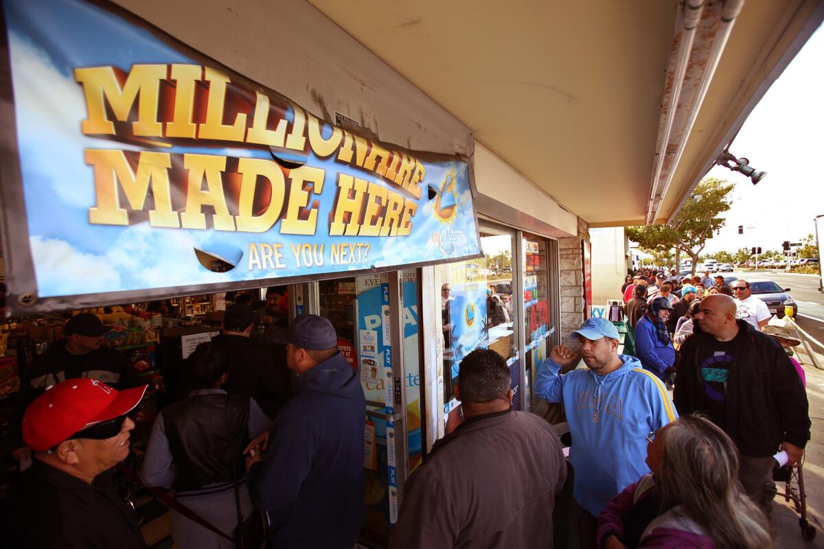 People wait in a long and thick line to buy a Powerball lottery ticket from Bluebird Liquor, hoping to win the $1.5 billion jackpot in Hawthorne.