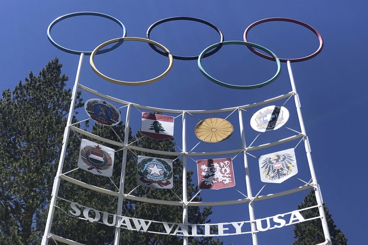 The Olympic rings stand atop a sign reading Squaw Valley USA