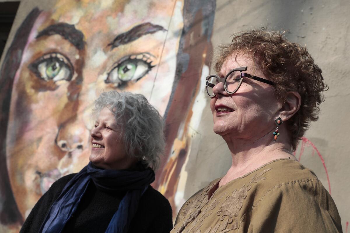 Constance Mallinson, left, and Merion Estes on the streets of the Arts District.