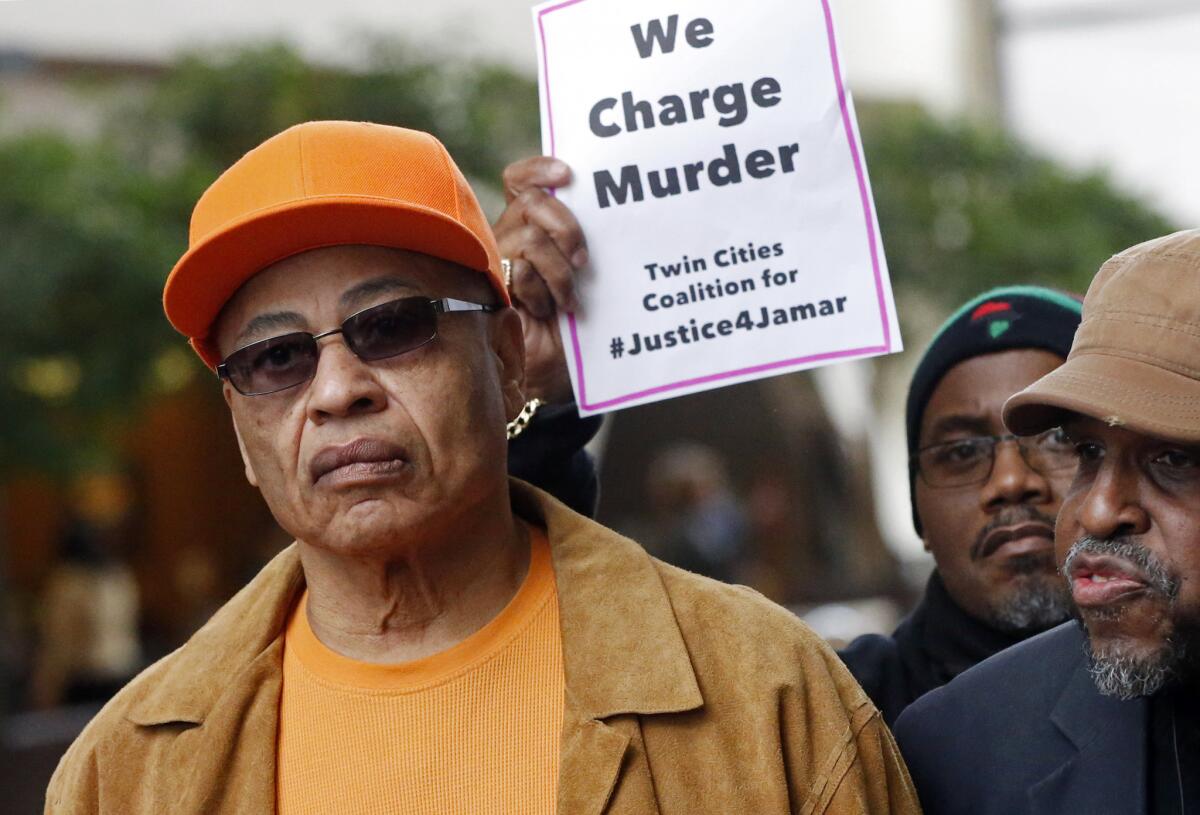 James Clark, right, the father of Jamar Clark, at a news conference March 17 in Minneapolis.