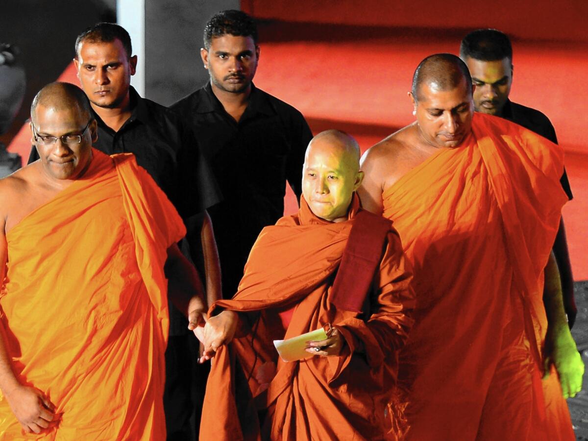 "Most Muslims destroy our country, our people and the Buddhist religion," says Buddhist monk Wirathu, center, of Myanmar, seen in 2014.