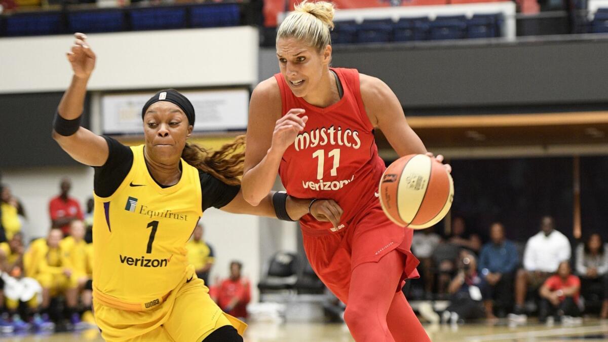 Mystics guard Elena Delle Donne (11) drives to the basket against Sparks guard Odyssey Sims during the first half Thursday in Washington.