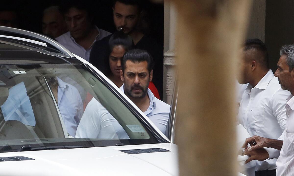 Bollywood actor Salman Khan, center, leaves his residence to travel to court in Mumbai, India, on May 8.