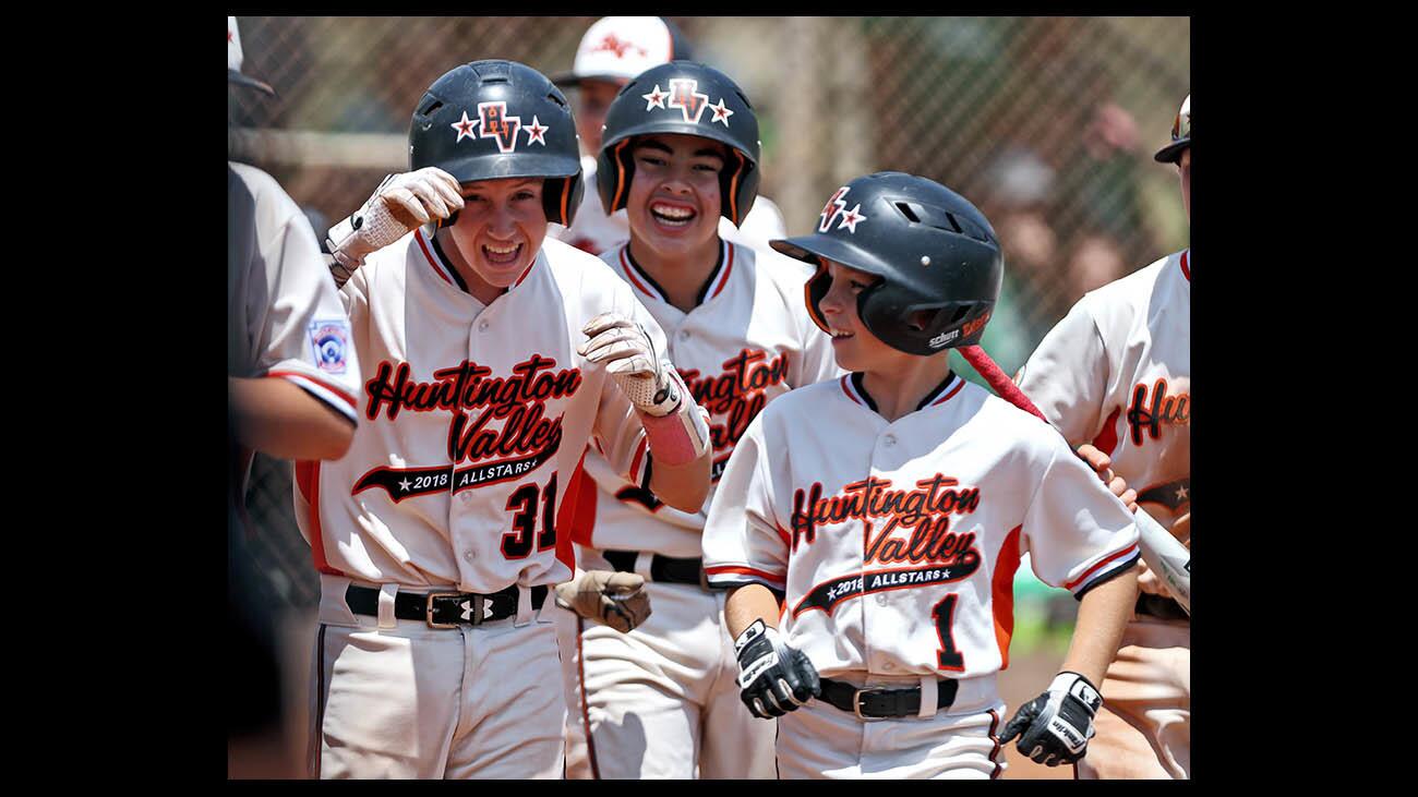 Huntington Valley All-Stars player #31 Gage Everson, left, is congratulated after hitting the second of back-to-back home-runs to put his team up 2-1 in the Southern Divisional Championship Game vs. Park View All-Stars (San Diego) at Woodfield Park in Aliso Viejo on Saturday, July 28, 2018. HV lost 5-2.