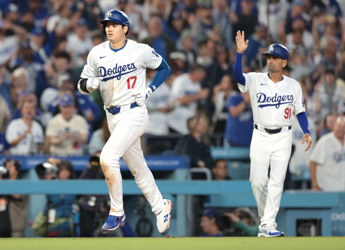 The Dodgers' Shohei Ohtani rounds the bases after hitting a two-run home run against the Rangers.