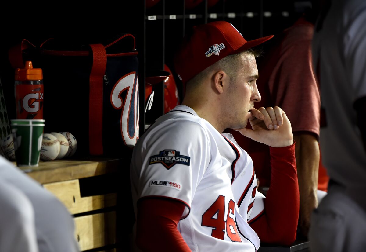Washington Nationals pitcher Patrick Corbin watches from the dugout.