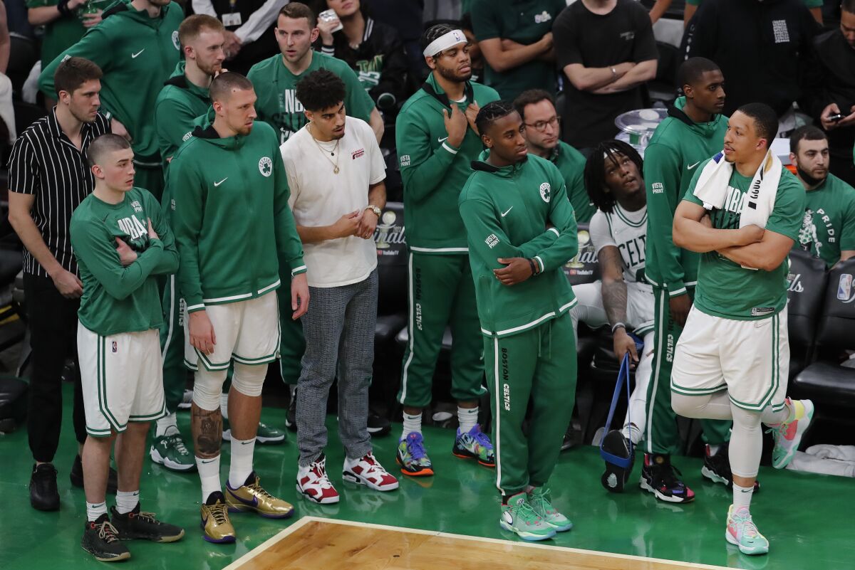 The Boston Celtics react from the sidelines during the fourth quarter of Game 4 of basketball's NBA Finals against the Golden State Warriors, Friday, June 10, 2022, in Boston. (AP Photo/Michael Dwyer)