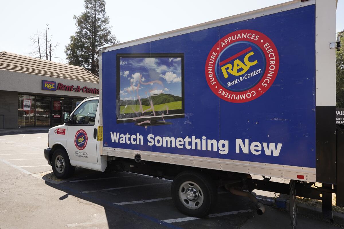 A Rent-A-Center delivery truck is seen in Sacramento, Calif., Tuesday, Aug. 2, 2022. California Attorney General Rob Bonta announced, Tuesday, Aug. 2, 2022, that Rent-A-Center, one of the nation's largest rent-to-own companies will pay $15.5 million to settle California'a allegations that it misled and overcharged tens of thousands of customers. (AP Photo/Rich Pedroncelli)