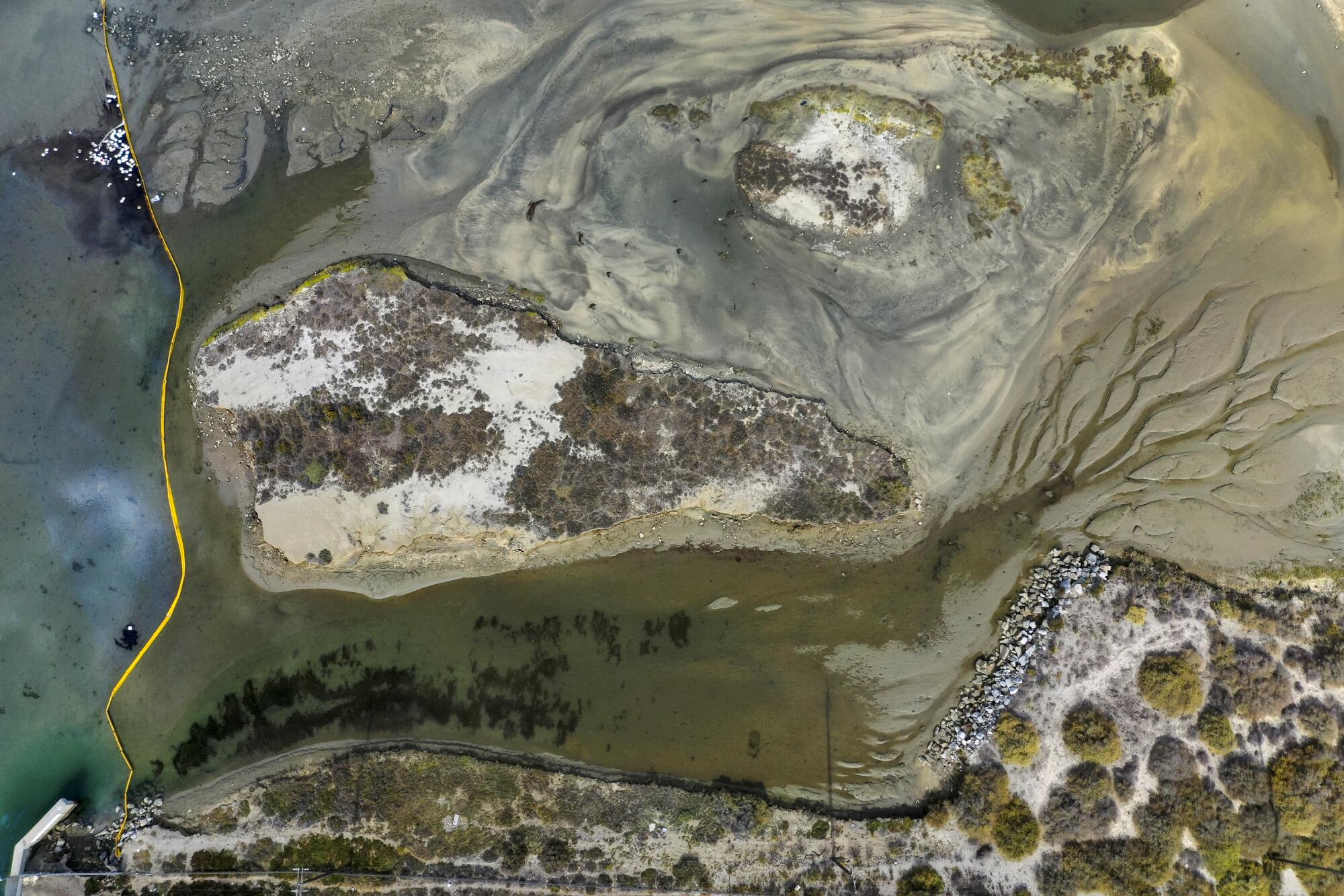 An aerial view of booms placed to help stop the oil from spreading further