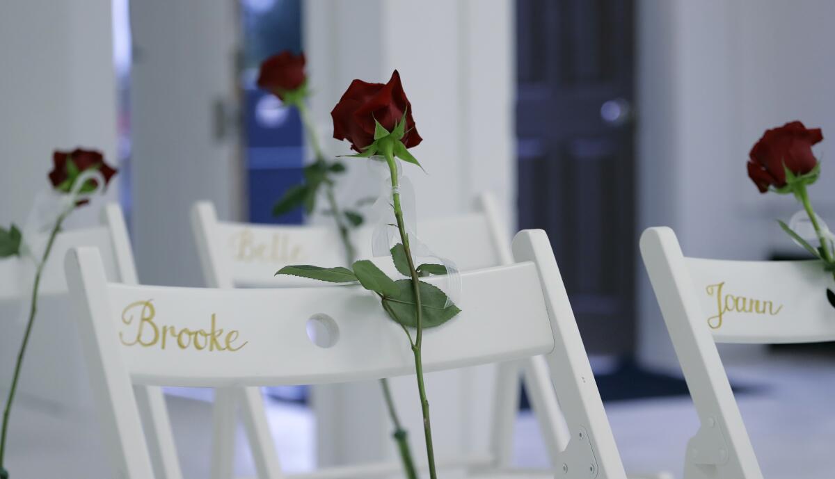 Roses are placed on twenty-six white chairs painted with the first names of the victims of the Texas shooting attack.