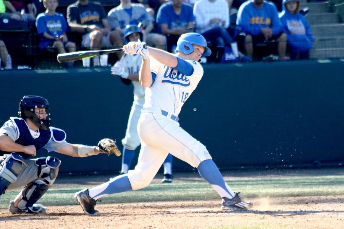 UCLA outfielder Kort Peterson hits a ball up the middle against North Carolina.